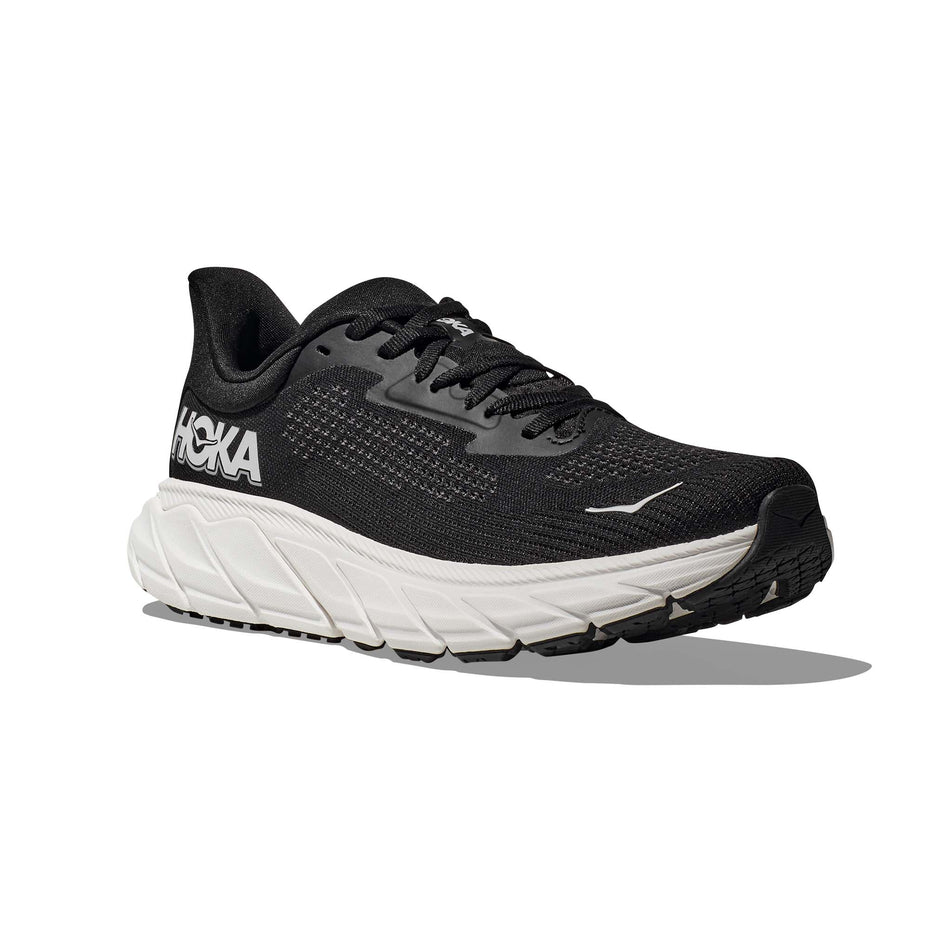 Lateral side of the right shoe from a pair of HOKA Men's Arahi 7 Wide Running Shoes in the Black/White colourway (8146233753762)