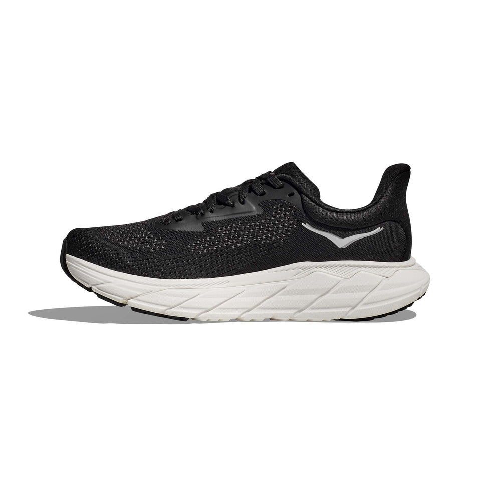 Medial side of the right shoe from a pair of HOKA Men's Arahi 7 Wide Running Shoes in the Black/White colourway (8146233753762)