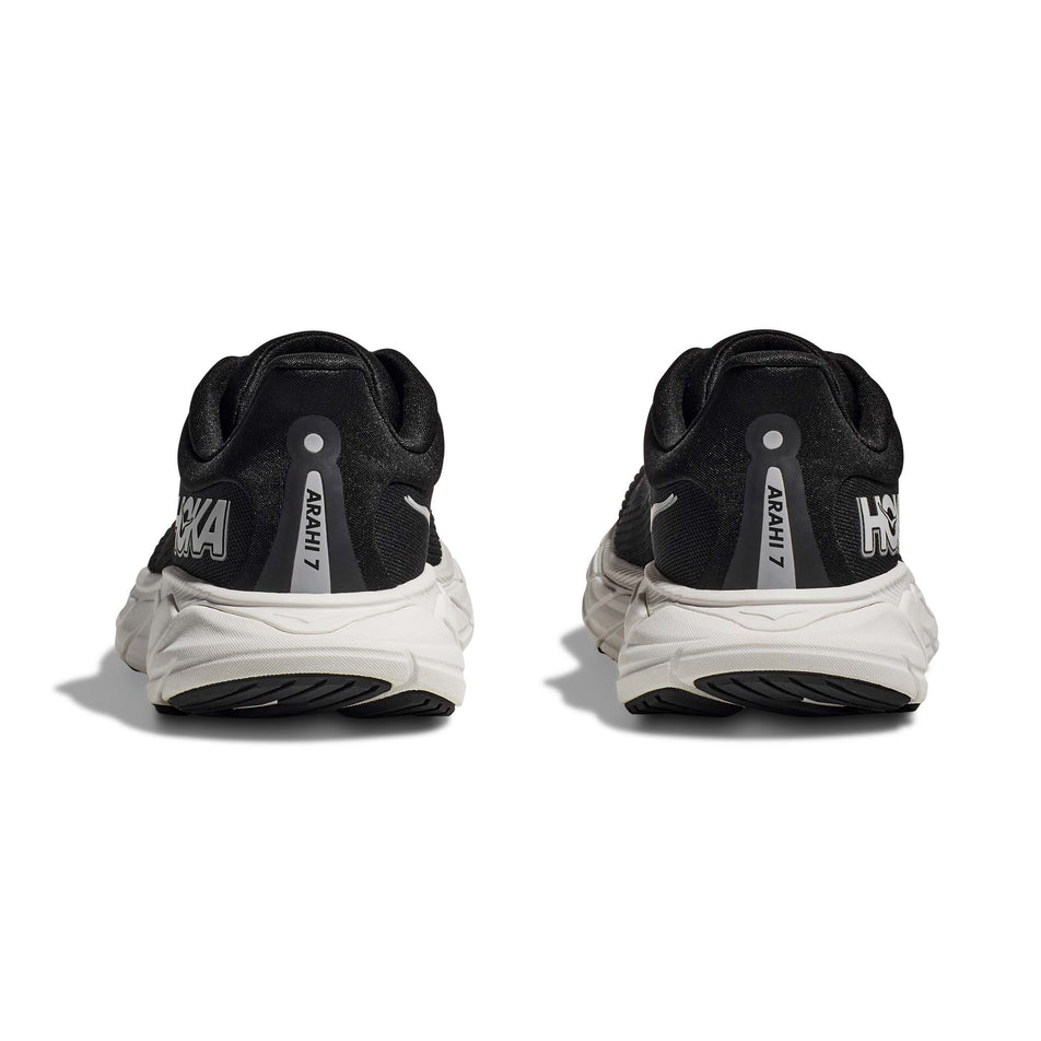 The back of a pair of HOKA Women's Arahi 7 Wide Running Shoes in the Black/White colourway (8146247123106)