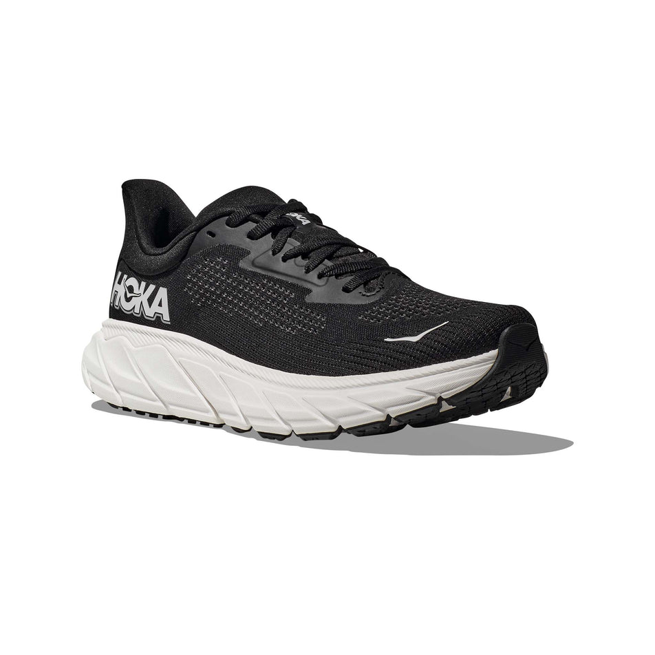 Lateral side of the right shoe from a pair of HOKA Women's Arahi 7 Wide Running Shoes in the Black/White colourway (8146247123106)