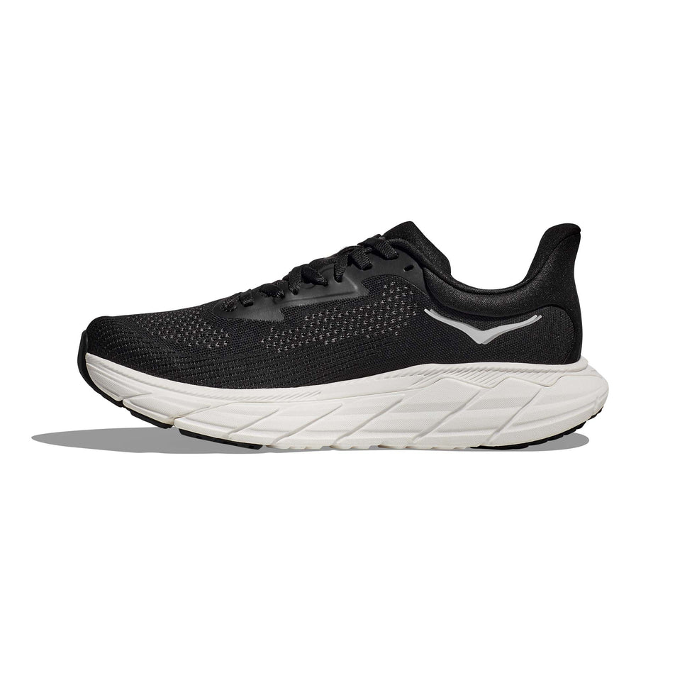 Medial side of the right shoe from a pair of HOKA Women's Arahi 7 Wide Running Shoes in the Black/White colourway (8146247123106)