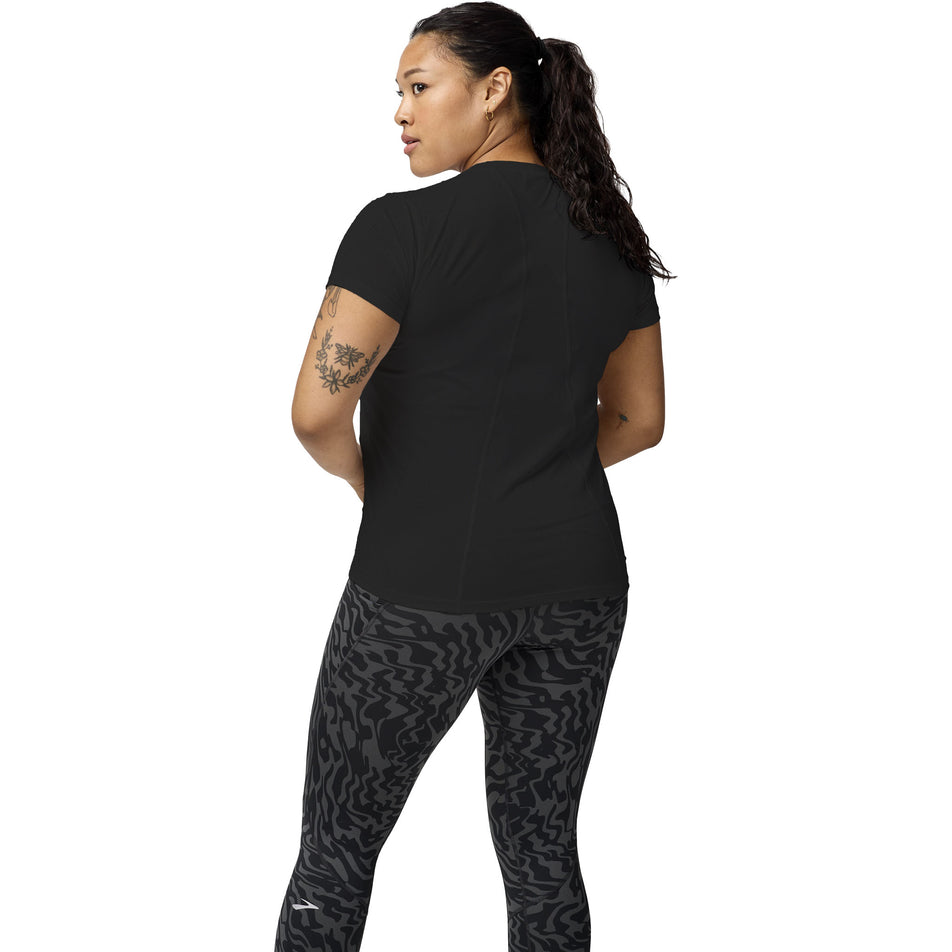 Back view of a model wearing the Brooks Women's Sprint Free Short Sleeve 3.0 in the Black colourway. (8575025414306)