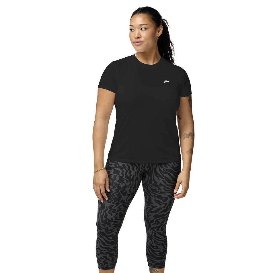 Front view of a model wearing the Brooks Women's Sprint Free Short Sleeve 3.0 in the Black colourway. (8575025414306)