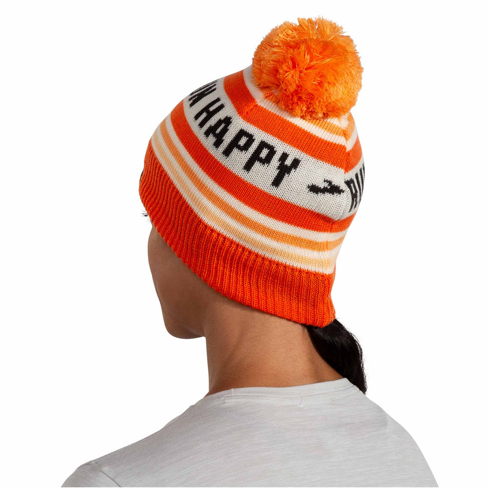 Back view of a model wearing the Brooks Unisex Heritage Pom Beanie in the Fluoro Flash Run Happy colourway.  (8511194333346)