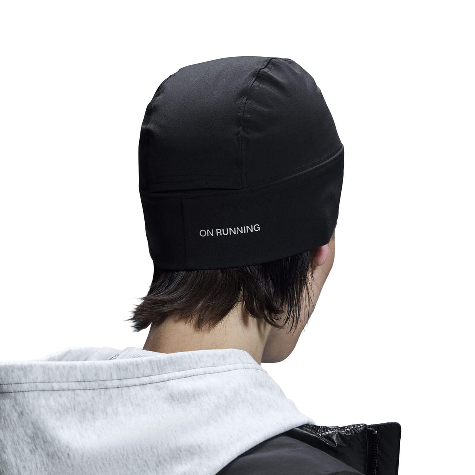 Back view of a model wearing an On Core Beanie in the Black colourway.  (8534546186402)