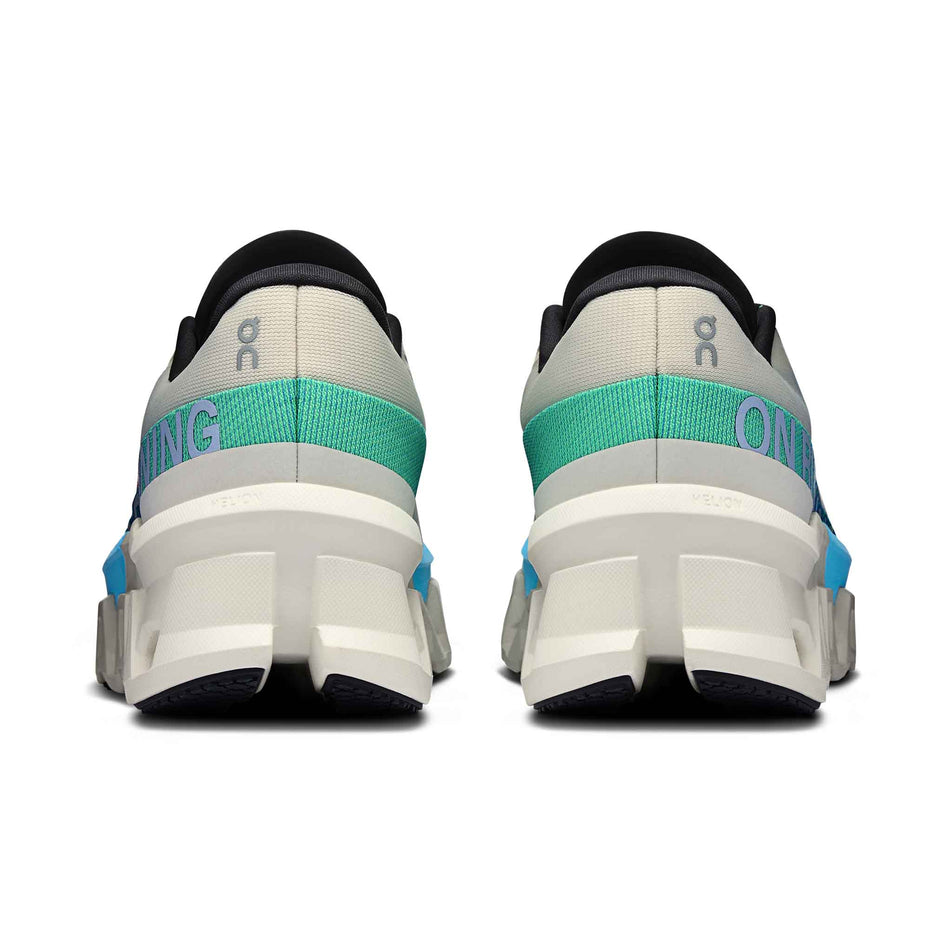 The back of a pair of On Women's Cloudmonster 2 Running Shoes in the Cream/Horizon colourway. (8562846498978)