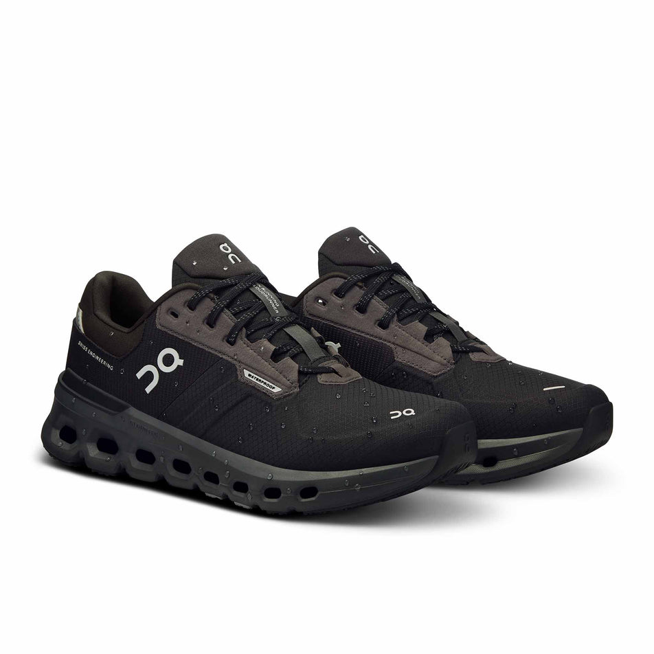 A pair of On Women's Cloudrunner 2 Waterproof Running Shoes in the Magnet/Black colourway. There are water droplets on the shoes. (8534539600034)