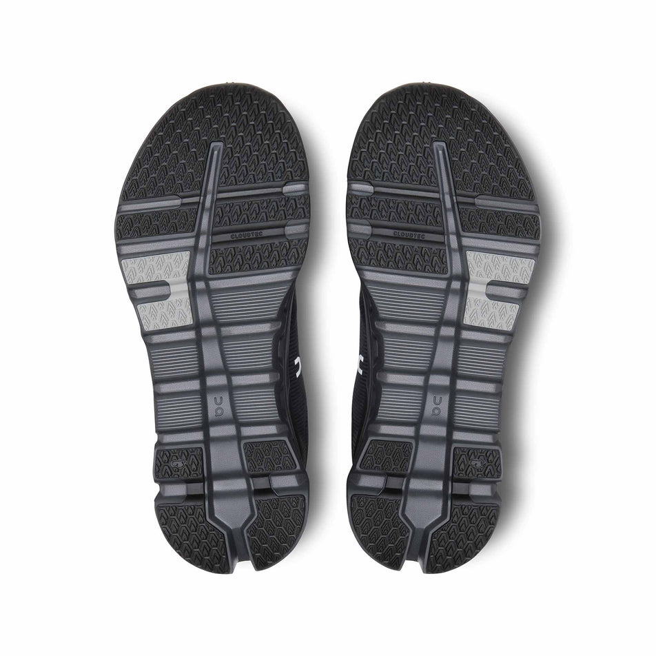 The outsoles on a pair of On Women's Cloudrunner 2 Waterproof Running Shoes in the Magnet/Black colourway. (8534539600034)