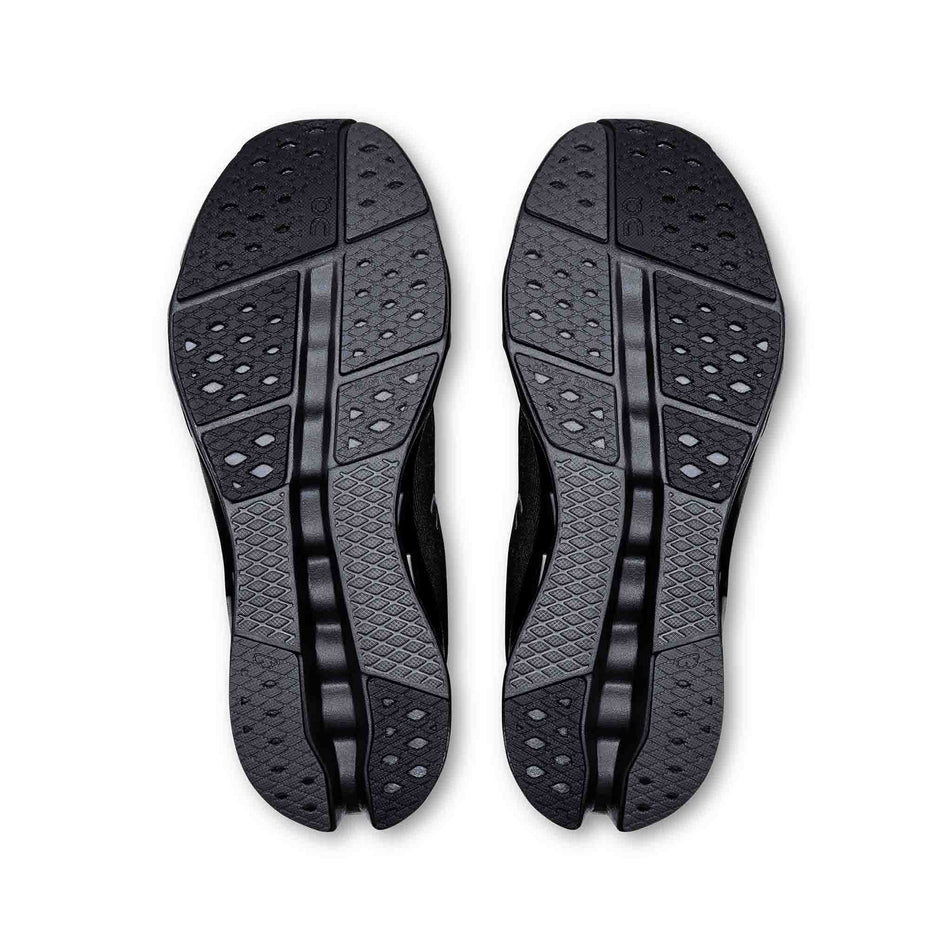 The outsoles on a pair of On Women's Cloudsurfer 2 Running Shoes in the Black/Black colourway. (8577864007842)