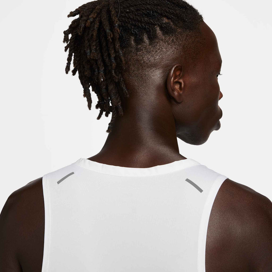 Close-up back view of a model wearing a Nike Men's Rise 365 Dri-FIT Running Tank in the White/Reflective Silv colourway. Only the upper section of the tank can be seen in the image. (8409892651170)