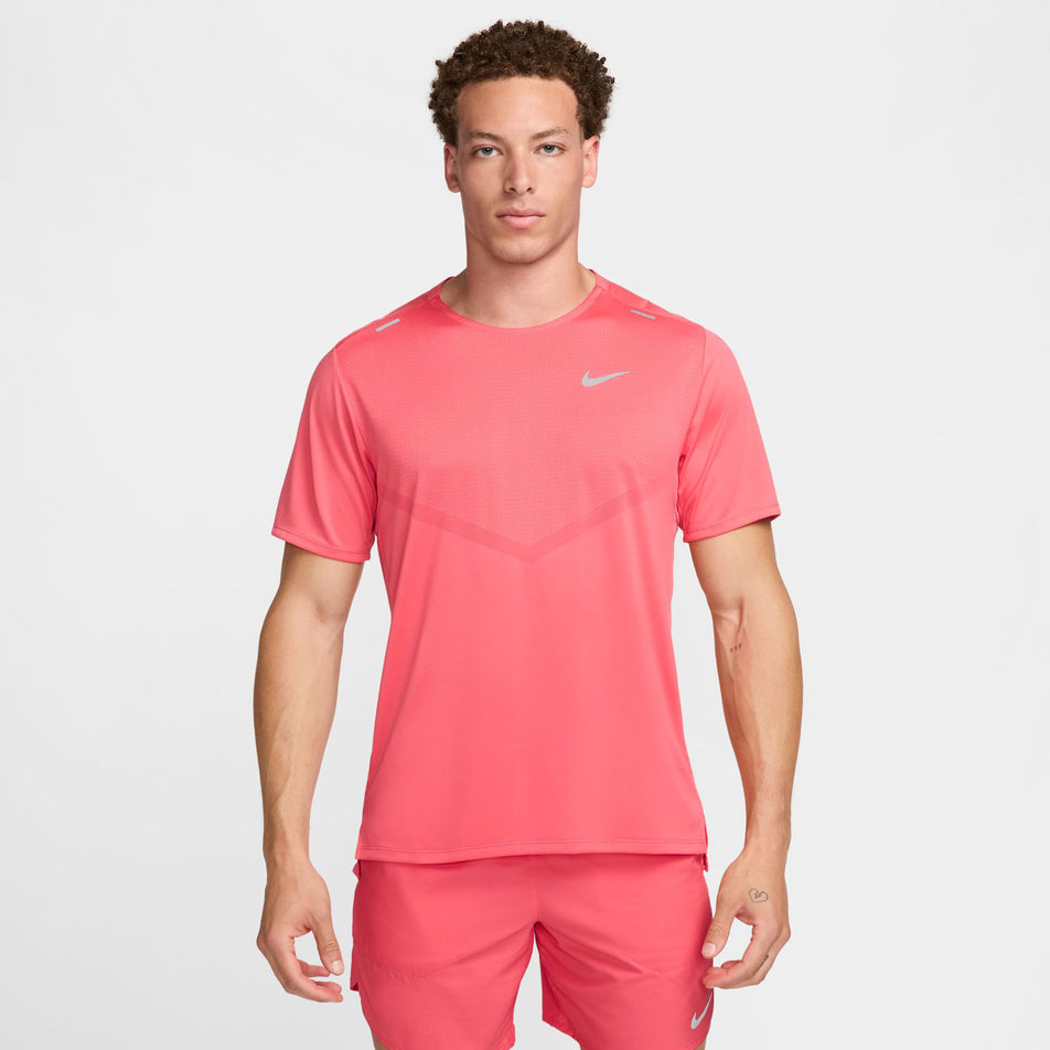 Front view of a model wearing a Nike Men's Rise 365 Dri-FIT Short-Sleeve Running Top in the Aster Pink/Reflective Silv colourway. Model is also wearing Nike running shorts. (8399204548770)