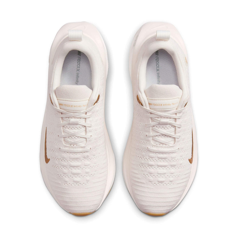 The uppers on a pair of Nike Women's InfinityRN 4 Road  unning Shoes in the Phantom/Metallic Gold-White colourway (8449418657954)