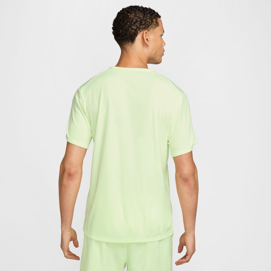 Back view of a model wearing the Nike Men's Miler Dri-FIT UV Short-Sleeve Running Top in the Barely Volt/Reflective Silver colourway. (8560184459426)