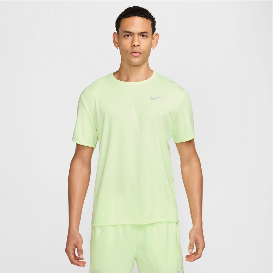 Front view of a model wearing the Nike Men's Miler Dri-FIT UV Short-Sleeve Running Top in the Barely Volt/Reflective Silver colourway.(8560184459426)