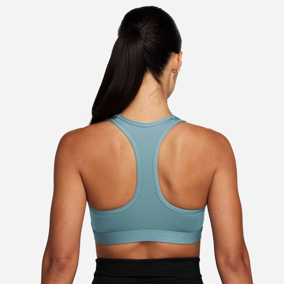 Back view of a model wearing a Nike Women's Swoosh Medium Support Padded Sports Bra in the Denim Turq/White colourway (8399176007842)