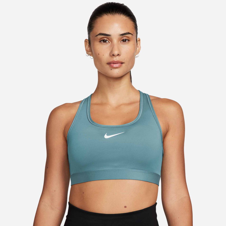 Front view of a model wearing a Nike Women's Swoosh Medium Support Padded Sports Bra in the Denim Turq/White colourway (8399176007842)