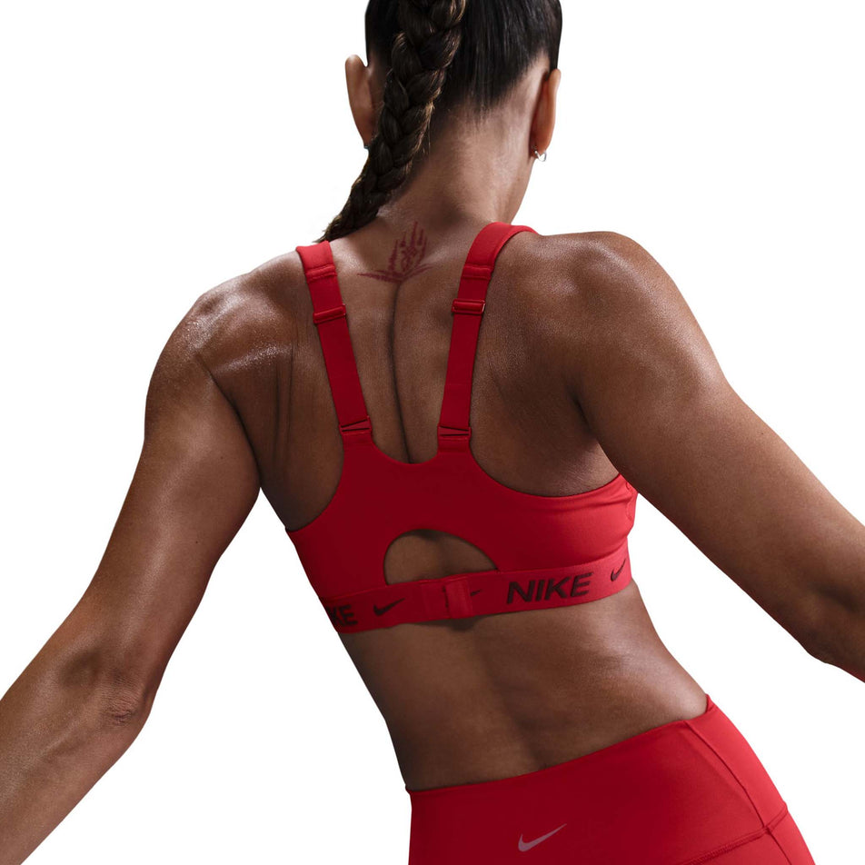 Back view of a model wearing a Nike Women's DrFIT Indy High Support Bra in the University Red/Dark Team Red colourway. (8560836477090)