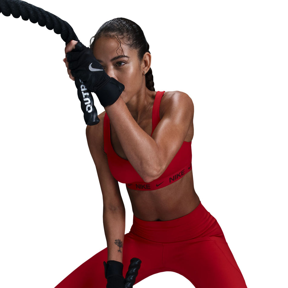 Front view of a model wearing a Nike Women's DrFIT Indy High Support Bra in the University Red/Dark Team Red colourway. (8560836477090)