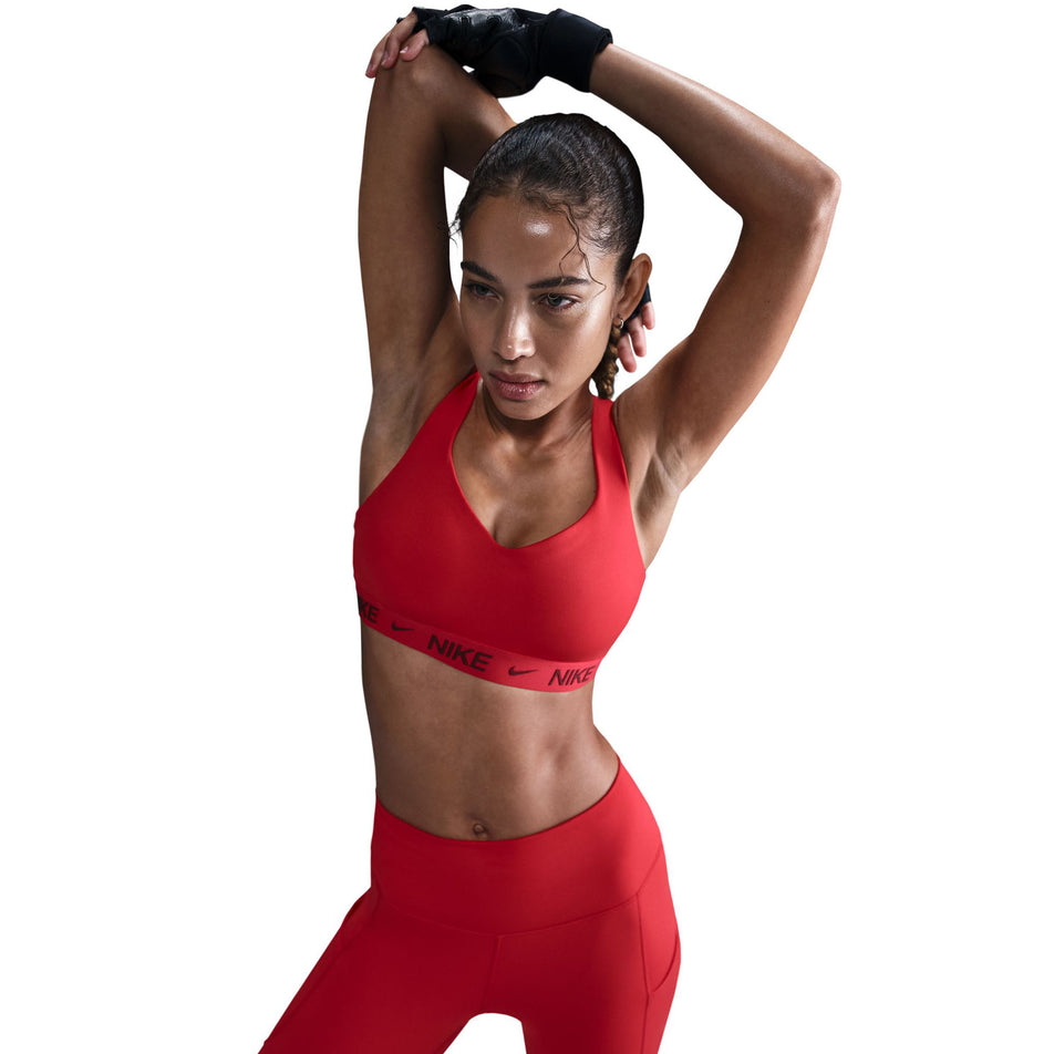 Front view of a model wearing a Nike Women's DrFIT Indy High Support Bra in the University Red/Dark Team Red colourway. (8560836477090)