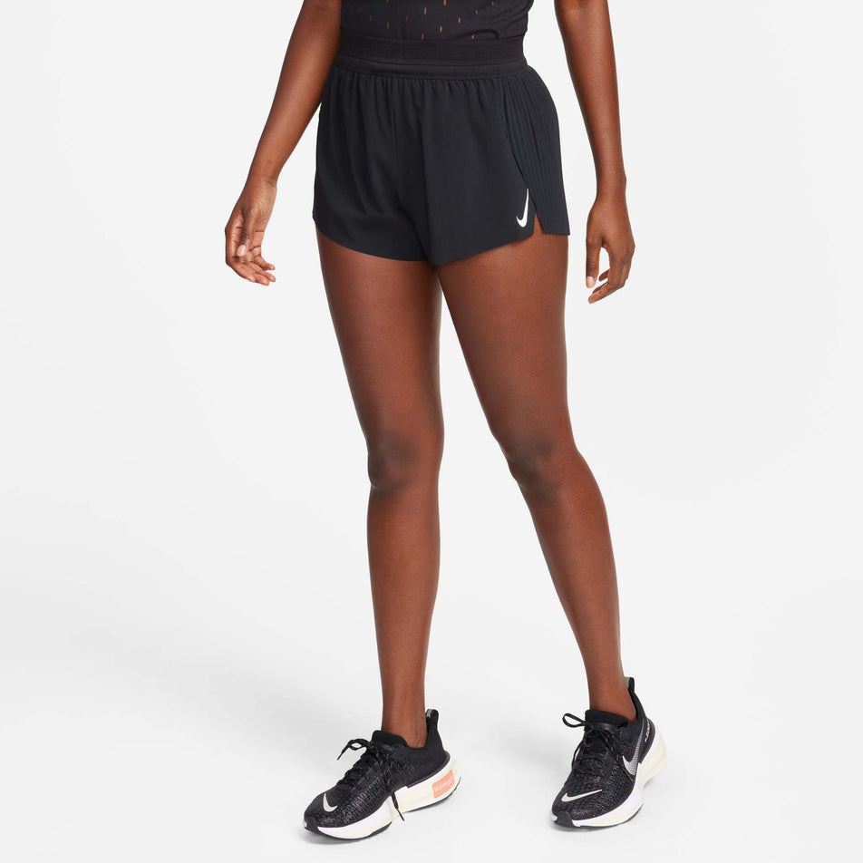 Front view of a model wearing a pair of Nike Women's AeroSwift Dri-FIT ADV Mid-Rise Brief-Lined 3