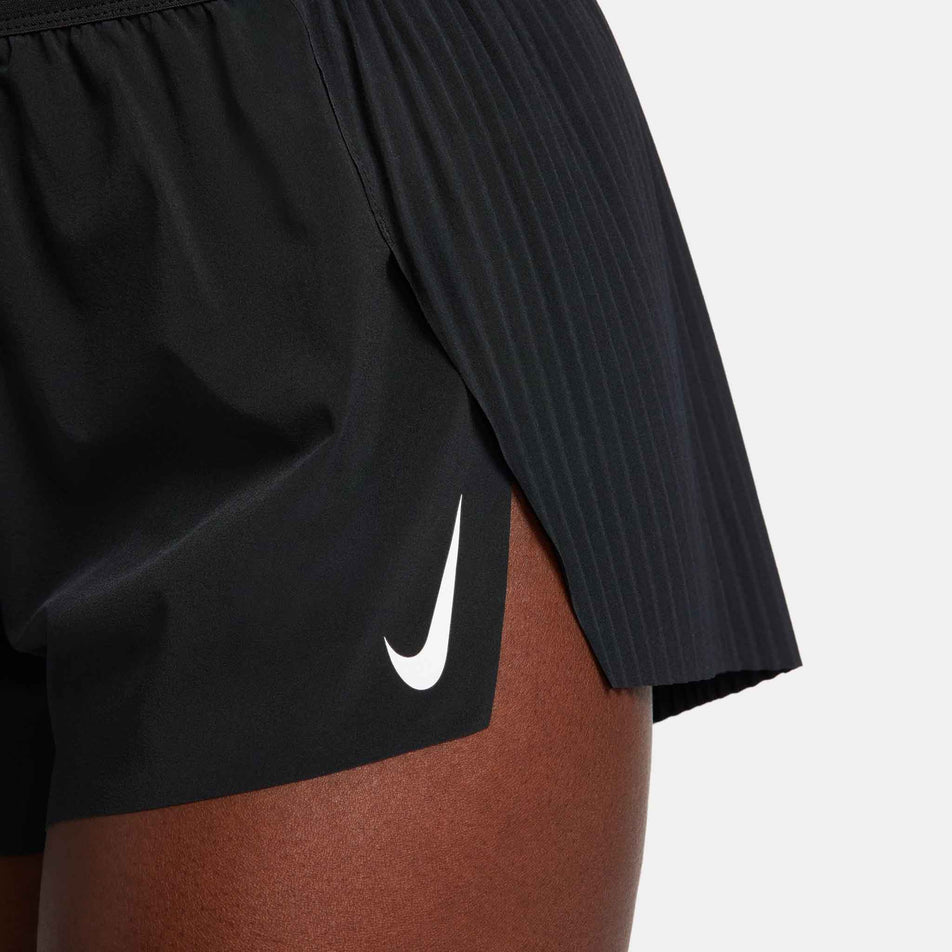 Close-up left-side view of a model wearing a pair of Nike Women's AeroSwift Dri-FIT ADV Mid-Rise Brief-Lined 3