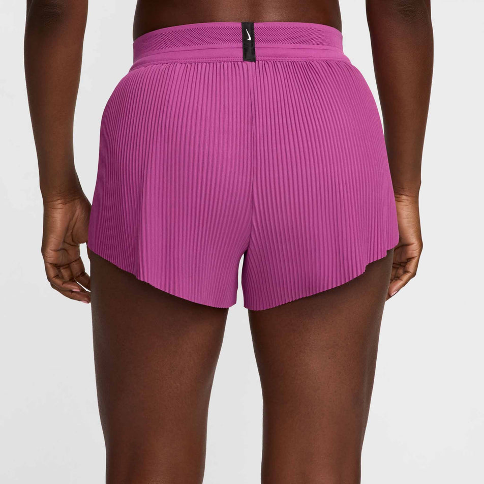 Back view of a model wearing a pair of Nike Women's AeroSwift Dri-FIT ADV Mid-Rise Brief-Lined 3