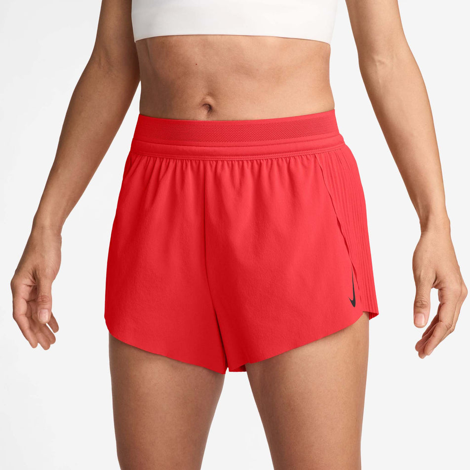 Front view of a model wearing a pair of Nike Women's AeroSwift Dri-FIT ADV Mid-Rise Brief-Lined 3