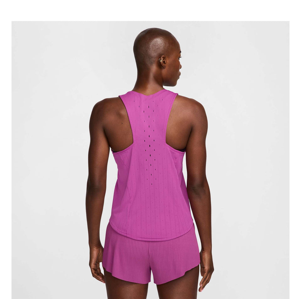 Back view of a model wearing a Nike Women's AeroSwift Dri-FIT ADV Running Singlet in the Hot Fuchsia/Black colourway. Model is also wearing Nike shorts. (8492375015586)