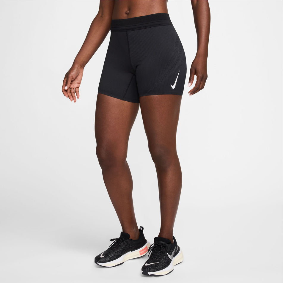 Angled-front view of a model wearing a pair of Nike Women's AeroSwift Dri-FIT ADV Mid-Rise 5