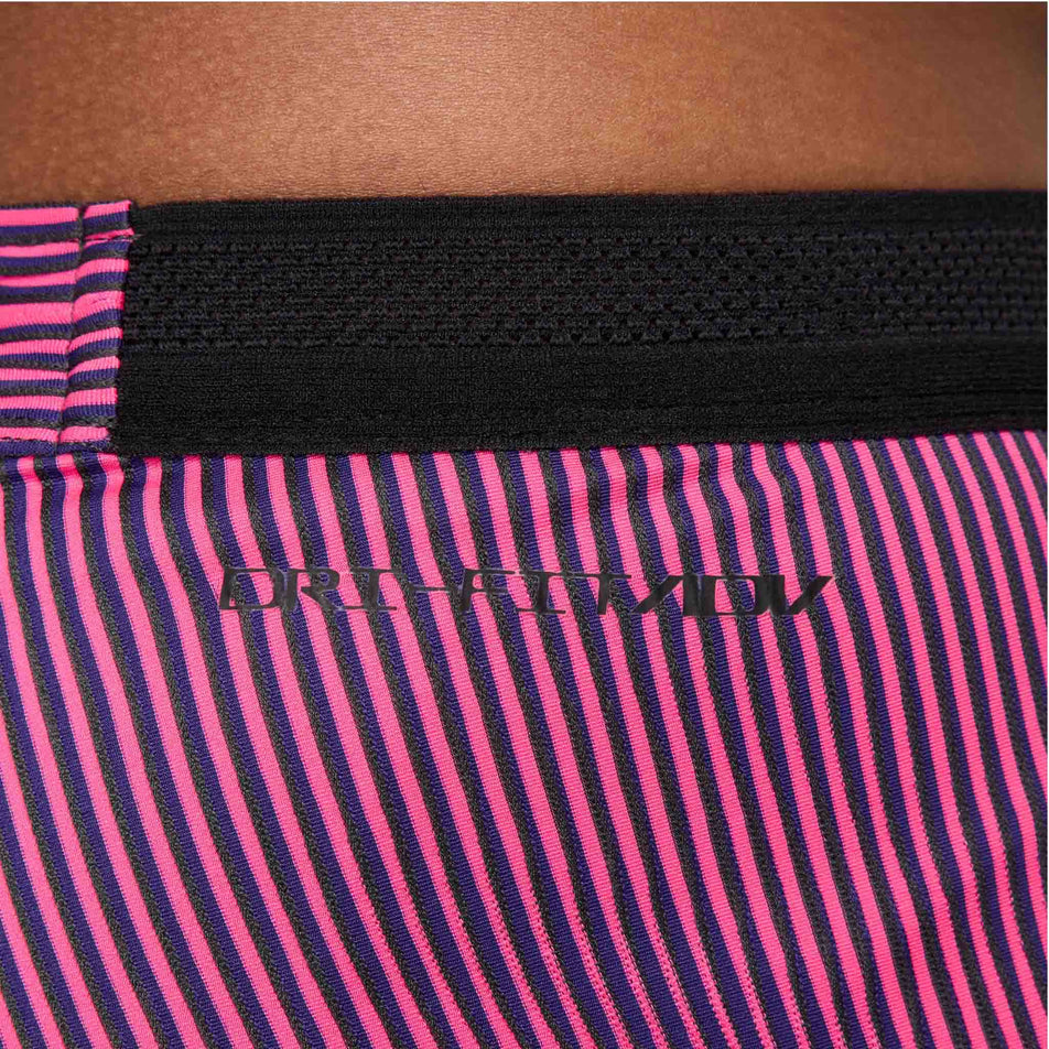 Close-up view of the waistband detail on a pair of Nike Men's Dri-FIT Aeroswift Brief-Lined Half Tights in the Anthracite/Hyper Pink/Court Purple Black colourway. Half tights are being worn by a model. (8483561013410)