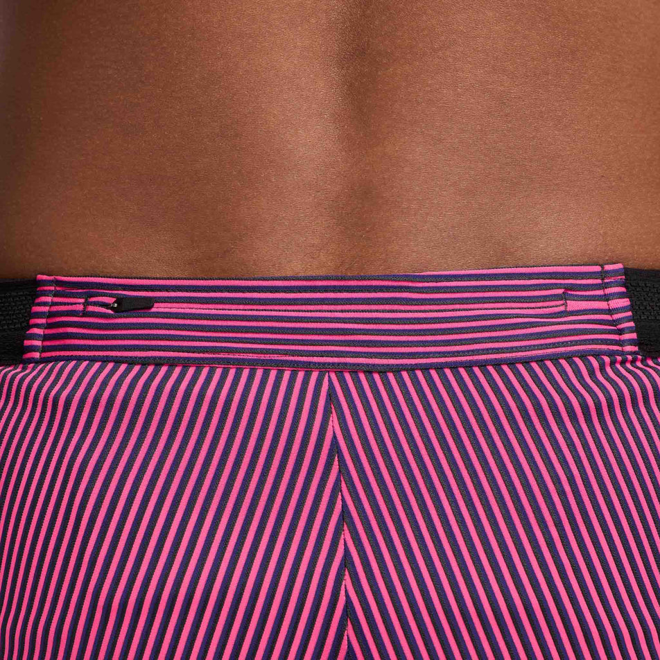 Close-up view of the zipped back pocket on a pair of Nike Men's Dri-FIT Aeroswift Brief-Lined Half Tights in the Anthracite/Hyper Pink/Court Purple Black colourway. Half tights are being worn by a model. (8483561013410)