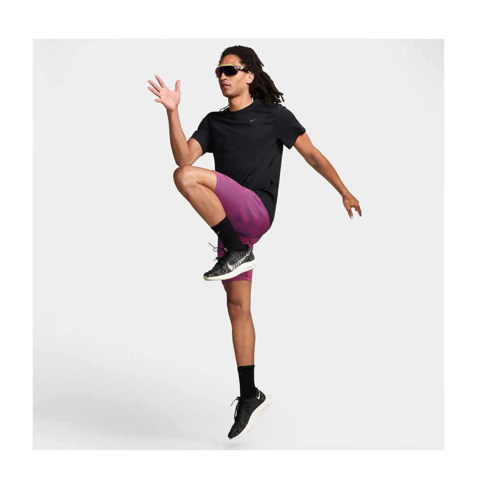 Front view of a model wearing a pair of Nike Men's Dri-FIT Aeroswift Brief-Lined Half Tights in the Anthracite/Hyper Pink/Court Purple Black colourway. Model is also wearing Nike socks, shoes, sunglasses, and a t-shirt - and is in a running pose. (8483561013410)