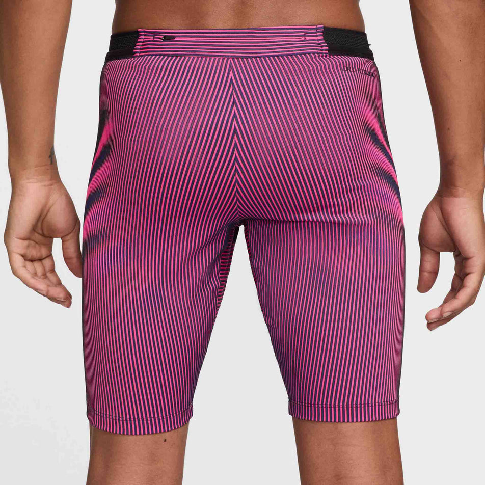 Back view of a model wearing a pair of Nike Men's Dri-FIT Aeroswift Brief-Lined Half Tights in the Anthracite/Hyper Pink/Court Purple Black colourway. (8483561013410)