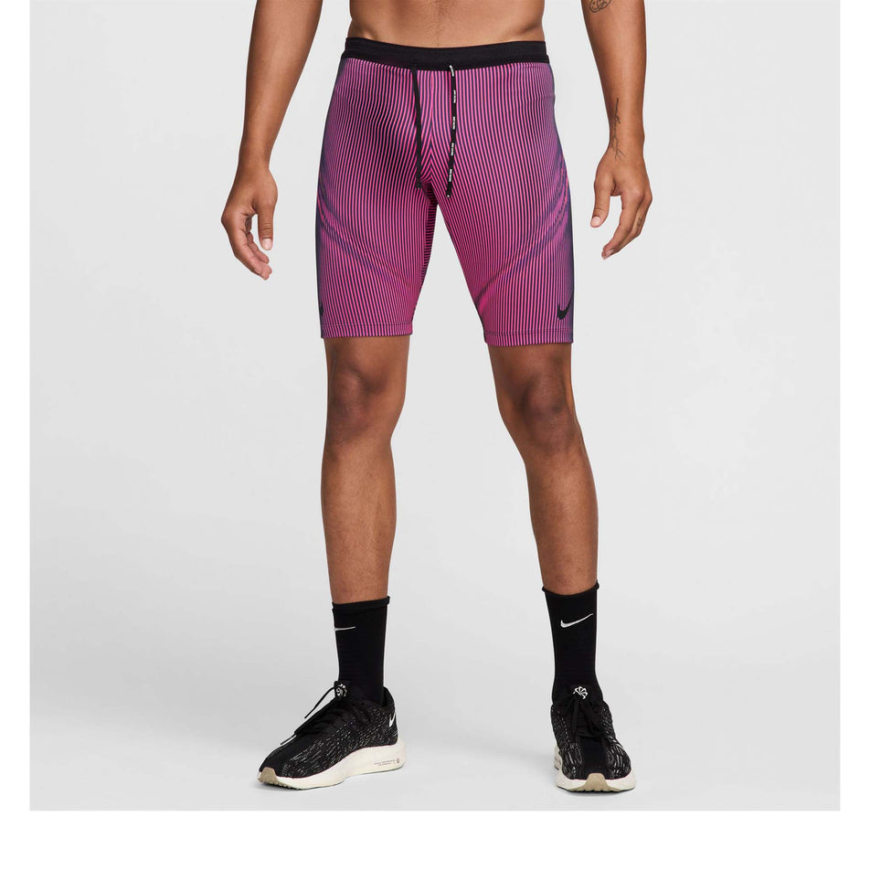 Front view of a model wearing a pair of Nike Men's Dri-FIT Aeroswift Brief-Lined Half Tights in the Anthracite/Hyper Pink/Court Purple Black colourway. Model is also wearing Nike socks and shoes. (8483561013410)