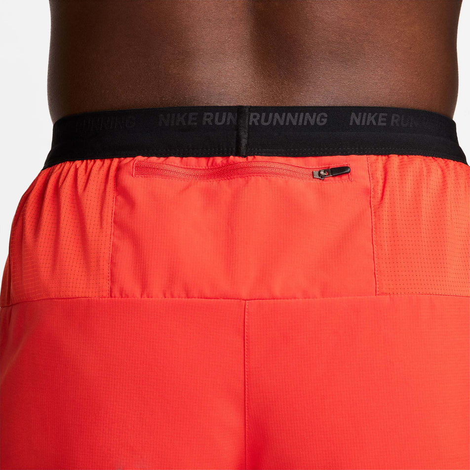 Close-up back view of the zippered back pocket on a pair of Nike Men's Flex Stride Run Energy 5