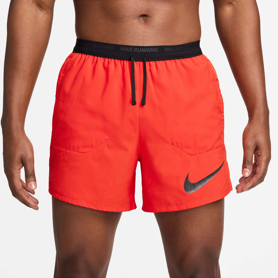 Front view of a model wearing a pair of Nike Men's Flex Stride Run Energy 5