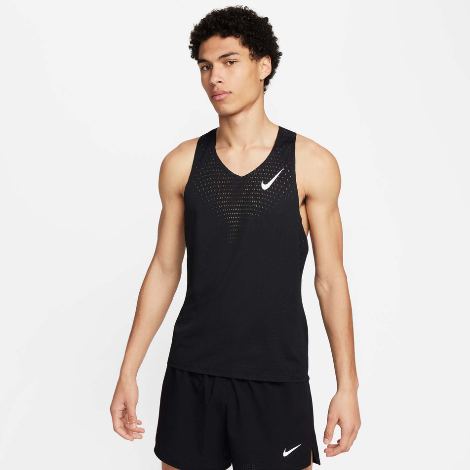 Front view of a model wearing a Nike Men's AeroSwift Dri-FIT ADV Running Singlet in the Black/Summit White colourway. Model is also wearing Nike shorts. (8393096462498)