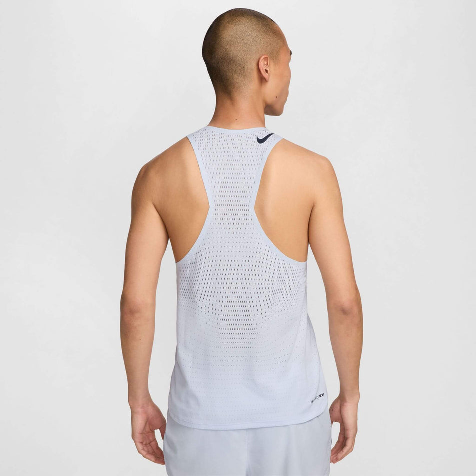 Back view of a model wearing a Nike Men's AeroSwift Dri-FIT ADV Running Singlet in the Football Grey/Dark Obsidian colourway. Model is also wearing Nike running shorts. (8399202058402)