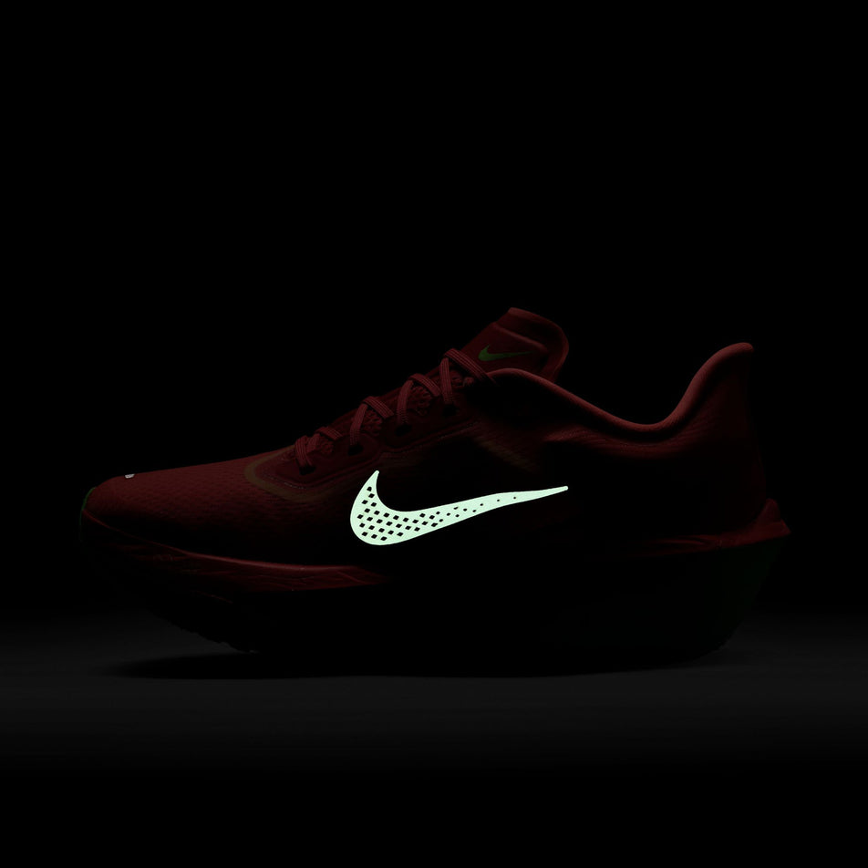 The reflective Swoosh on the medial side of the right shoe from a pair of Nike Women's Zoom Fly 6 Running Shoes in the Bright Crimson/Cave Purple-Lime Blast colourway. (8571094663330)