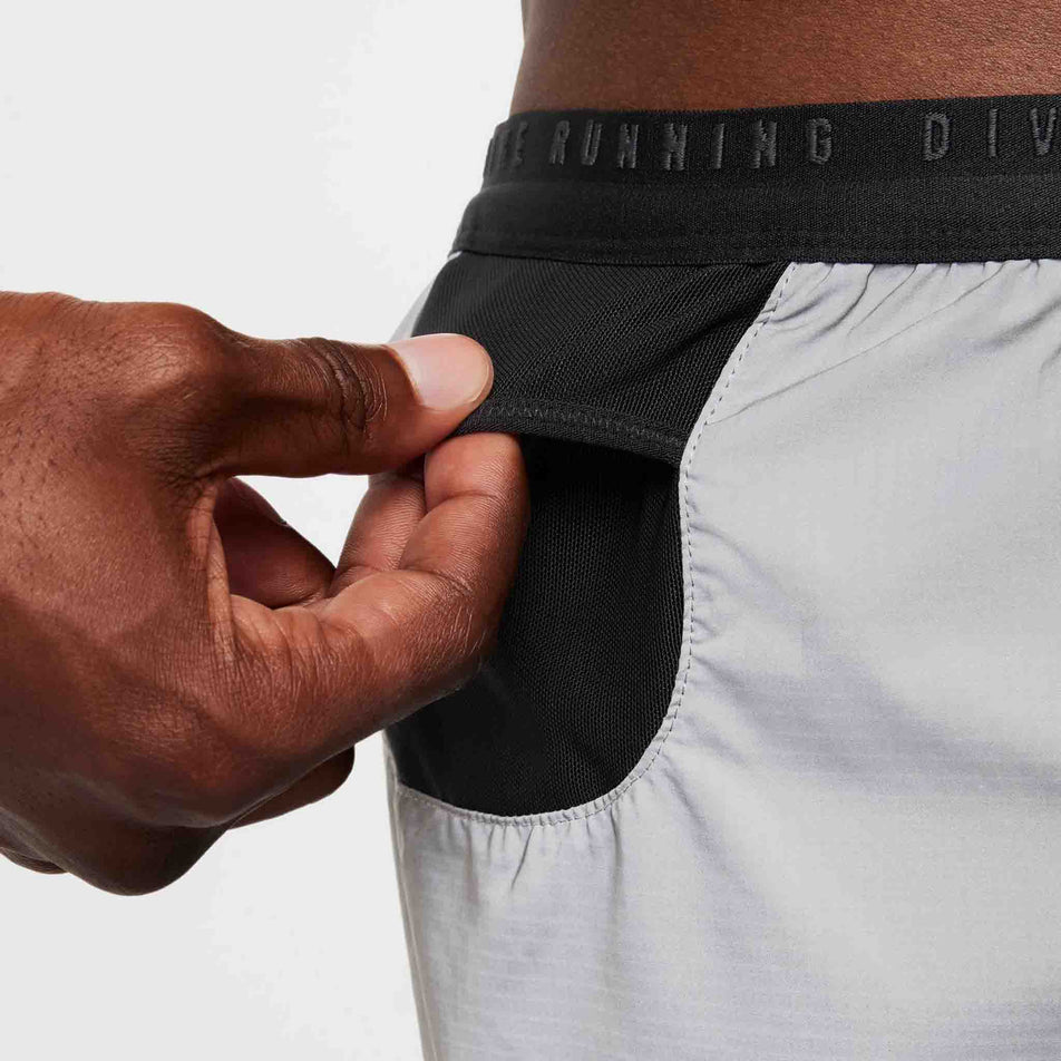 Close-up view of the drop-in pocket on the right side of a pair of Nike Men's Dri-FIT ADV Running Division 4