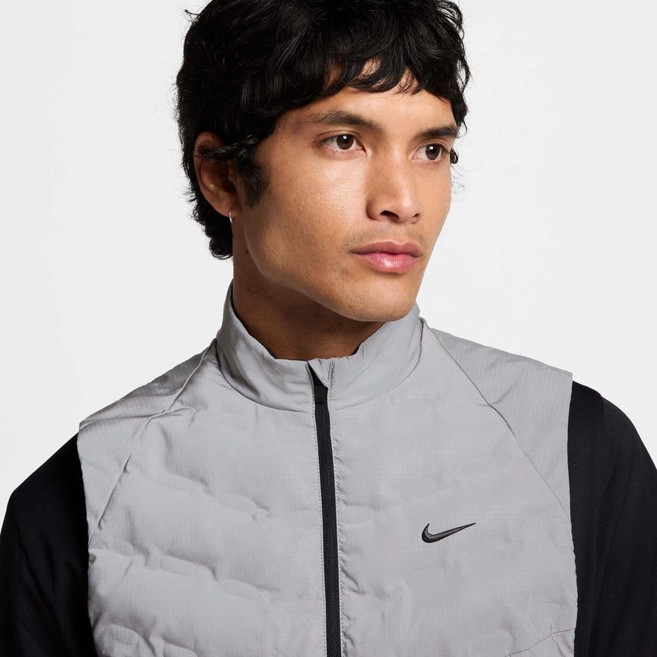 Close-up front view of a model wearing the Nike Men's Therma-FIT Running Division ADV Running Vest. Only the upper part of the top can be seen in the image. (8497736941730)