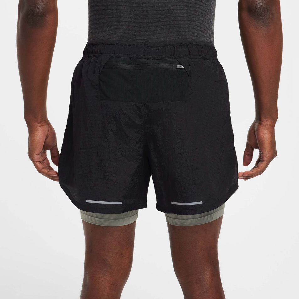 Back view of a model wearing the Nike Men's Dri-FIT Water-Repellent Running Division Stride 5