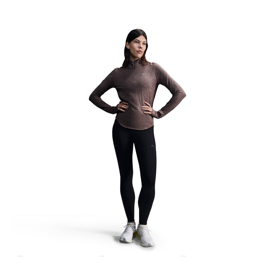 Front view of a model wearing a pair of Nike Women's Swift Dri-FIT High Rise 7/8 Running Tights in the Black/Reflective Silver colourway. (8560773759138)