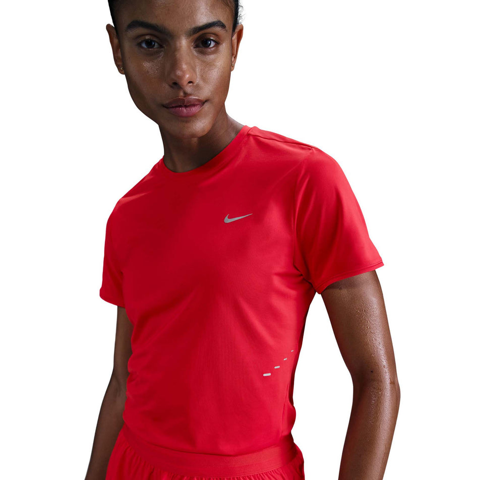 Front view of a model wearing a Nike Women's Swift Dri-FIT Short-Sleeve Running Top in the Light Crimson/Reflective Silver. (8560485662882)