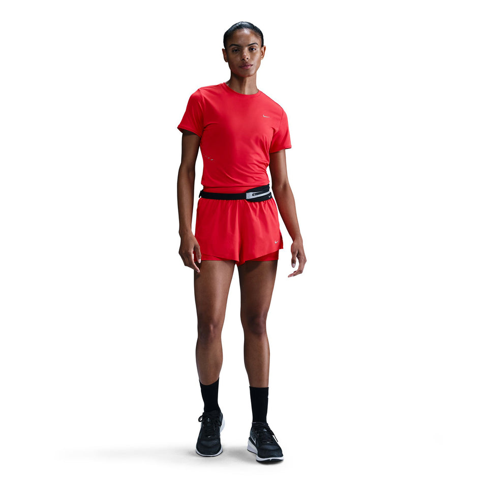 Front view of a model wearing a Nike Women's Swift Dri-FIT Short-Sleeve Running Top in the Light Crimson/Reflective Silver. (8560485662882)