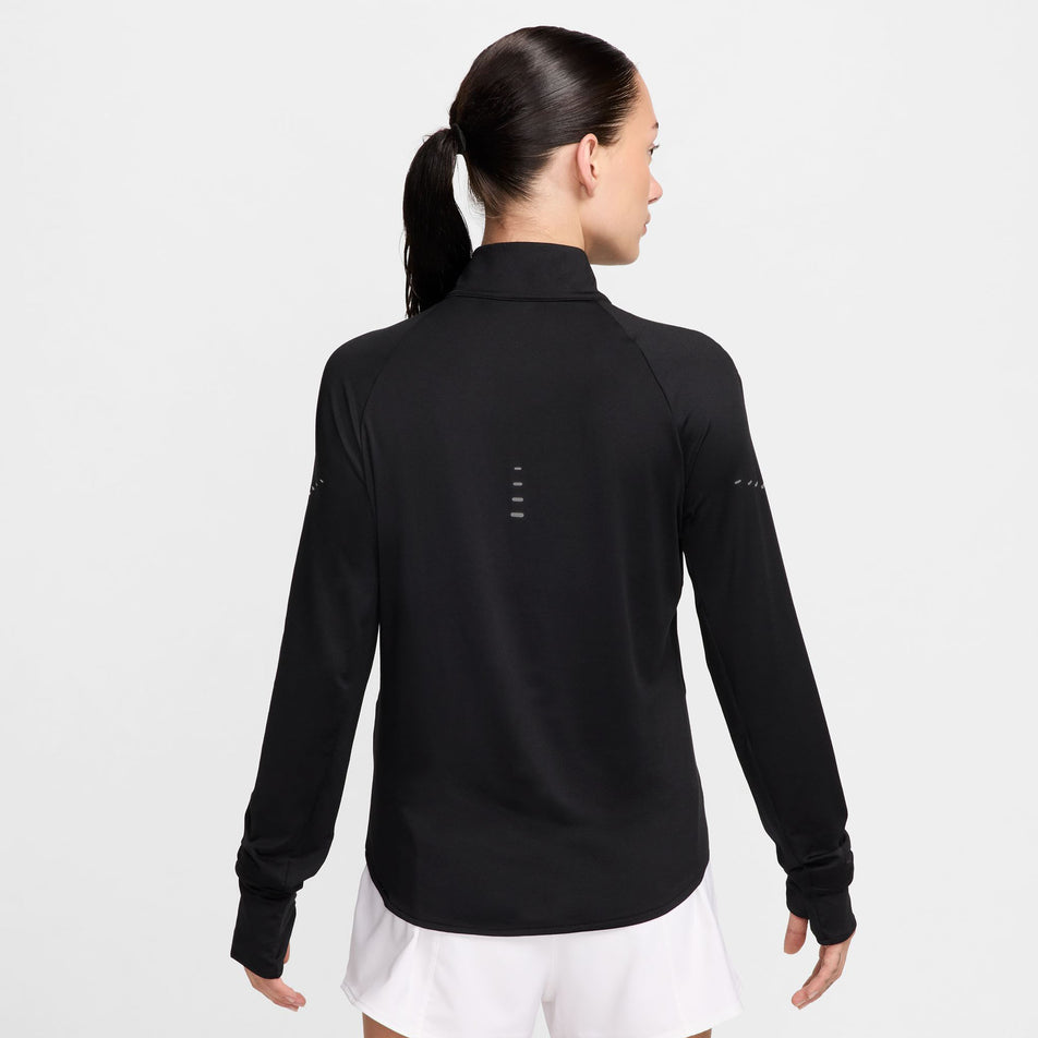 Back view of a model wearing a Nike Women's Swift Fri-FIT UV Half-Zip Long Sleeve Running Top in the Black/Reflective Silver colourway. (8560809312418)