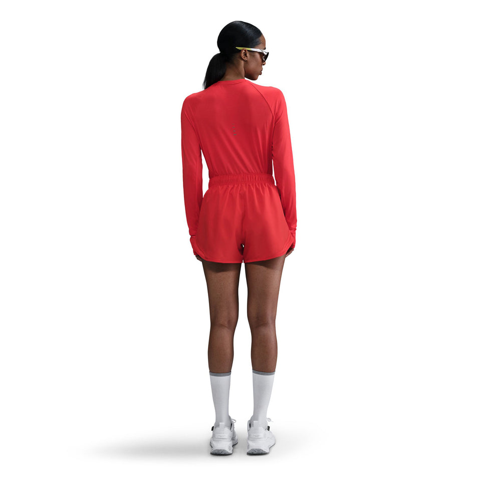 Back view of a model wearing a Nike Women's Swift Dri-FIT UV Long-Sleeve Crew Running Top in the Light Crimson/Reflective Silver colourway. (8560789553314)