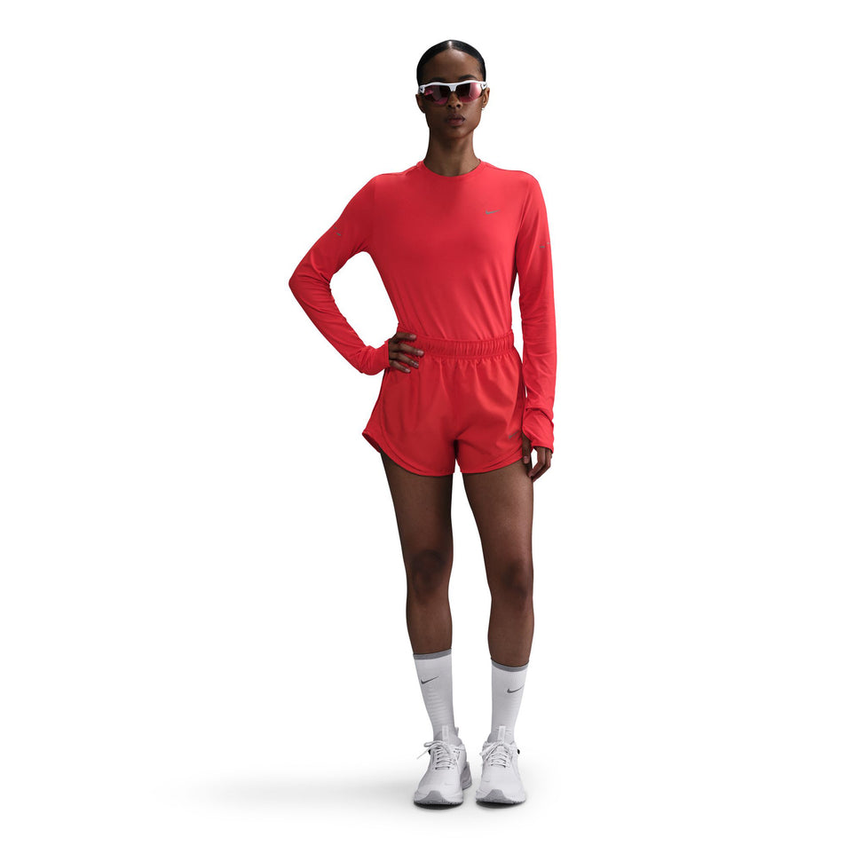 Front view of a model wearing a Nike Women's Swift Dri-FIT UV Long-Sleeve Crew Running Top in the Light Crimson/Reflective Silver colourway. (8560789553314)