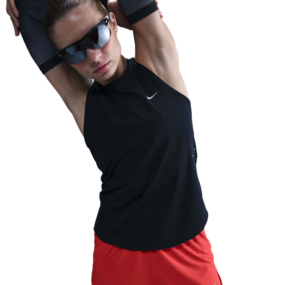 Front view of a model wearing a Nike Women's Swift Dri-FIT Running Tank Top in the Black/Reflective Silver colourway. (8560470524066)