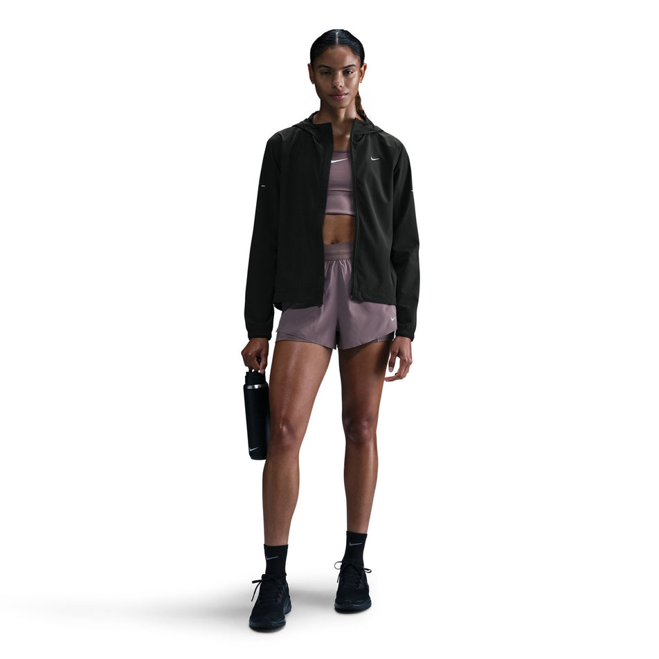 Front view of a model wearing a Nike Women's Swift Repel Packable Running Jacket in the Black/Reflective Silver colourway. (8560817635490)